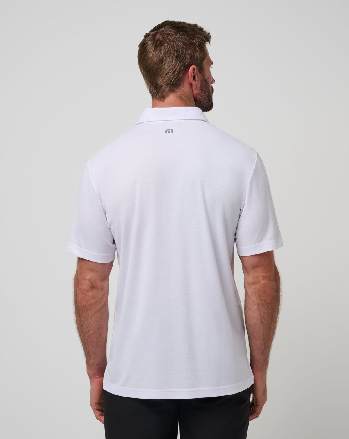 Nebraska Top Recruit Polo White/Black | Travis Mathew Smart Buy