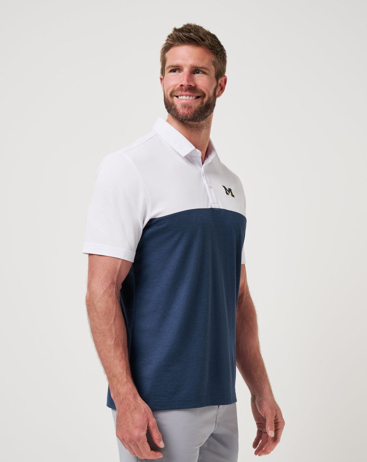 Michigan Drop Back Polo White/Navy | Travis Mathew Signature