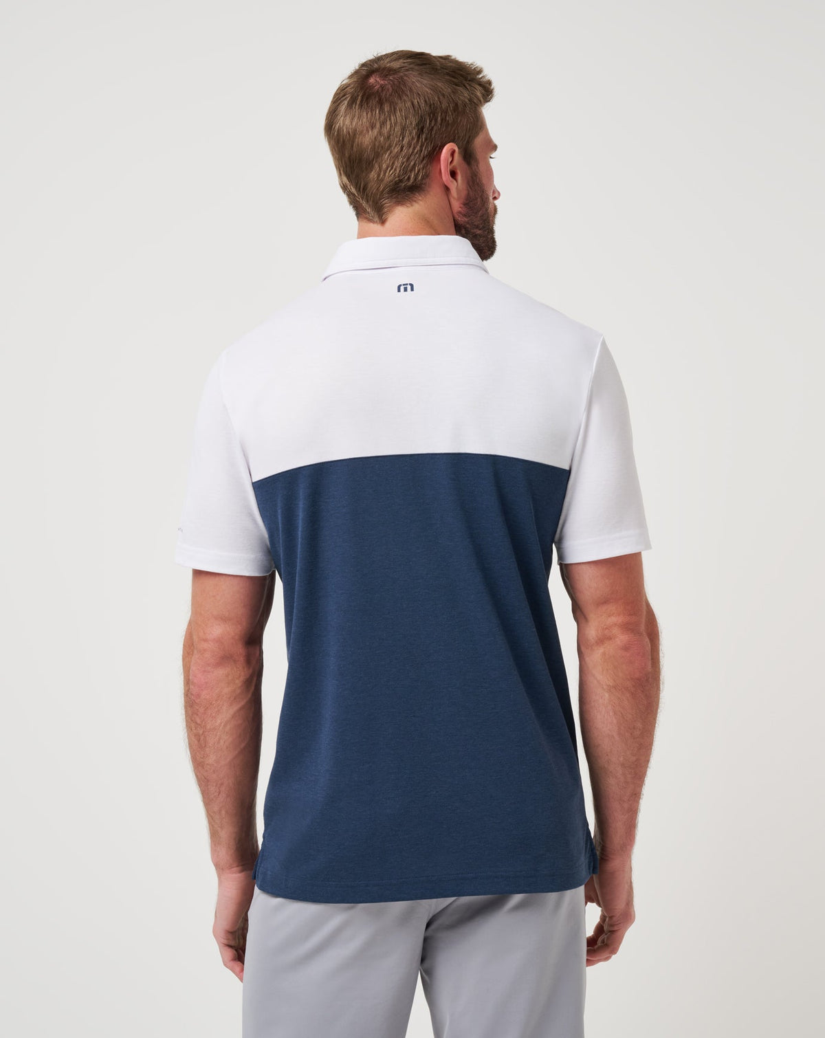 Michigan Drop Back Polo White/Navy | Travis Mathew Signature