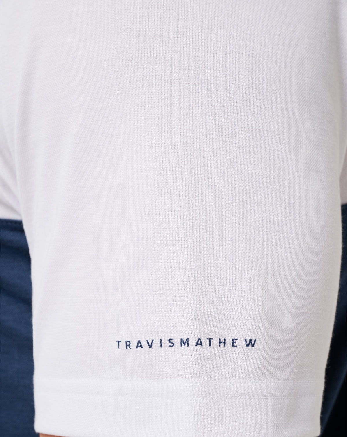 Michigan Drop Back Polo White/Navy | Travis Mathew Signature