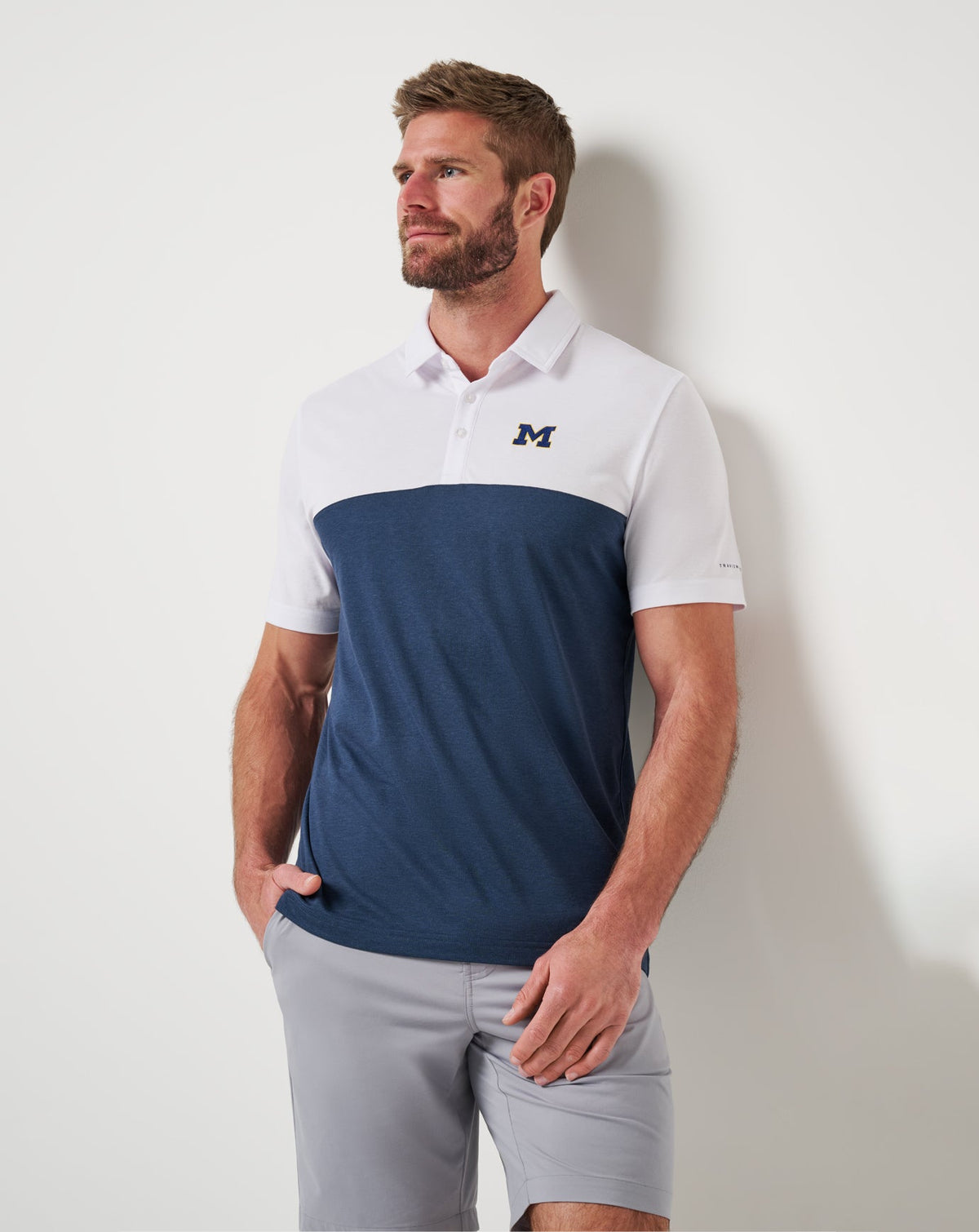 Michigan Drop Back Polo White/Navy | Travis Mathew Signature