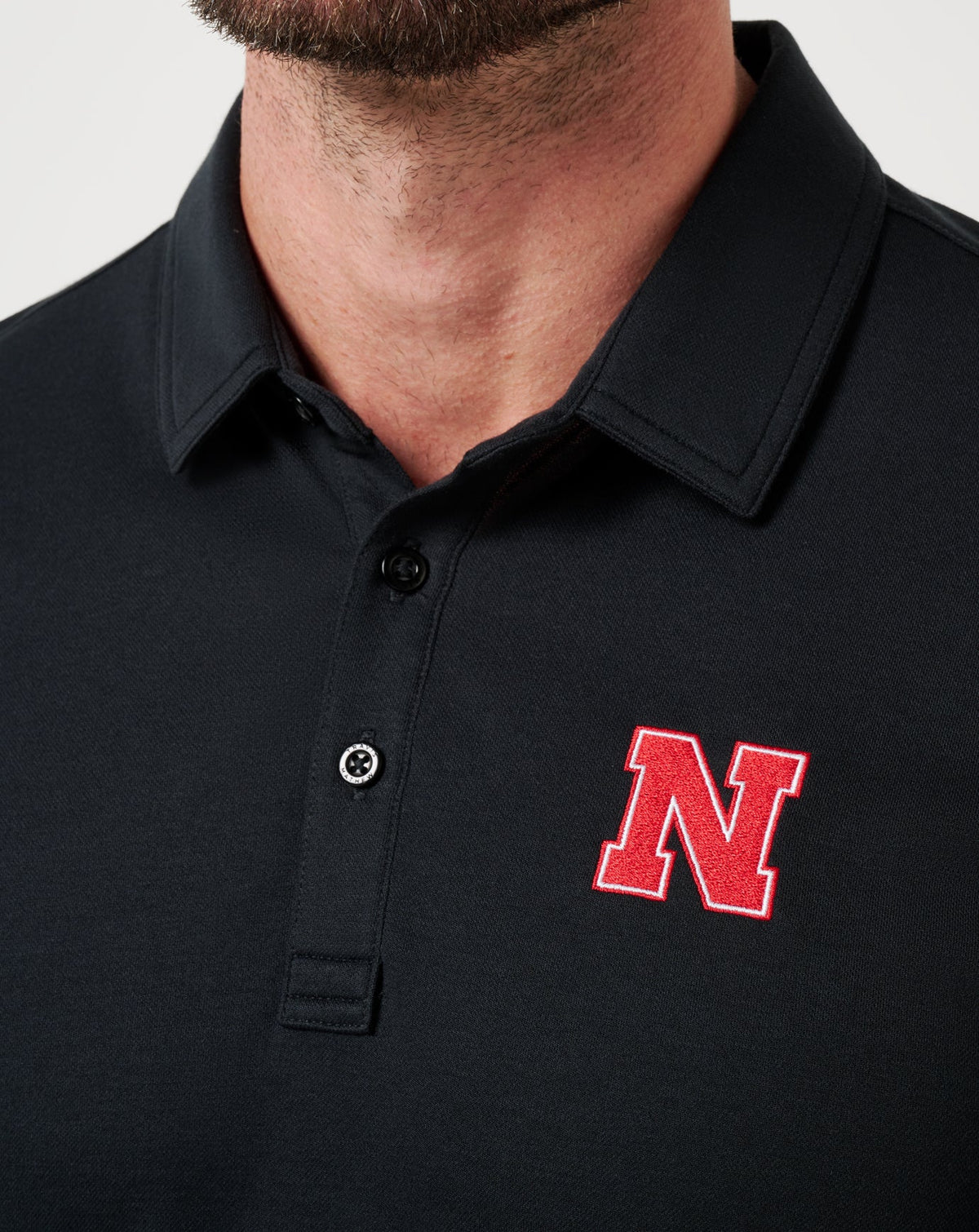 Nebraska School Pride Polo Black | Travis Mathew Smart Buy